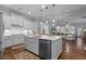 Bright kitchen features white cabinets, center island, copper faucet, and stainless steel appliances at 2792 River Vista Way, Mount Pleasant, SC 29466