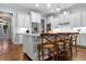 Bright kitchen features a center island, wood floors, white cabinets, stainless appliances, and barstool seating at 2792 River Vista Way, Mount Pleasant, SC 29466