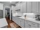 Bright kitchen features white subway tile, white cabinets, quartz counters, stainless appliances, and dark wood floors at 2792 River Vista Way, Mount Pleasant, SC 29466