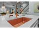 Close up of the kitchen island, copper faucet and sink with view into adjacent living room space at 2792 River Vista Way, Mount Pleasant, SC 29466