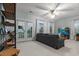 Bright living room with french doors, large windows, comfortable seating, ceiling fan, and a TV for relaxation and entertainment at 2792 River Vista Way, Mount Pleasant, SC 29466
