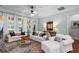 Bright living room with white sofas, stylish decor, and plenty of natural light at 2792 River Vista Way, Mount Pleasant, SC 29466