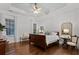 Spacious main bedroom with hardwood floors, a tray ceiling, and natural light at 2792 River Vista Way, Mount Pleasant, SC 29466