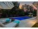 Stunning pool area at dusk featuring an in-ground pool, hot tub and lounge chairs at 2792 River Vista Way, Mount Pleasant, SC 29466