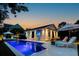 Beautifully lit pool area with lounge chairs and outdoor television for evening entertainment at 2792 River Vista Way, Mount Pleasant, SC 29466