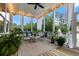 Inviting screened porch with comfortable seating, string lights, and a view of the backyard at 2792 River Vista Way, Mount Pleasant, SC 29466