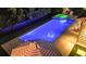 Aerial view of a modern pool with a lit spa and a patio with lounge seating and umbrellas at 2792 River Vista Way, Mount Pleasant, SC 29466