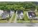 Picturesque aerial view of a neighborhood with lush greenery, a serene pond, and well-maintained homes at 2881 Rutherford Way, Charleston, SC 29414