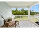 Cozy back porch with a blue patterned rug, wooden chairs, and peaceful backyard views at 2881 Rutherford Way, Charleston, SC 29414