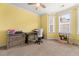 Bright bedroom with a desk, neutral carpet, yellow walls, and natural light streaming through a window at 2881 Rutherford Way, Charleston, SC 29414