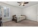 Bright bedroom featuring carpet, ceiling fan, and a bed with a patterned purple coverlet at 2881 Rutherford Way, Charleston, SC 29414