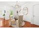 Bright dining area features a glass table with four upholstered chairs and view to front of the home at 2881 Rutherford Way, Charleston, SC 29414