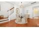 Bright dining area with a glass table, upholstered chairs, stairs, and doorway leading to the kitchen at 2881 Rutherford Way, Charleston, SC 29414