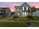 Charming two-story home with a covered front porch, manicured lawn, and lush landscaping at 2881 Rutherford Way, Charleston, SC 29414