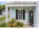 Cozy covered entryway featuring lush greenery and a stylish exterior light fixture at 2881 Rutherford Way, Charleston, SC 29414