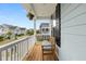 Inviting front porch with a wooden bench, white railing, and hanging flower basket at 2881 Rutherford Way, Charleston, SC 29414