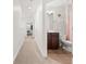 Bright hallway bathroom with tile floor, brown vanity, sink, and open view to bedroom at 2881 Rutherford Way, Charleston, SC 29414