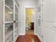 Hallway leading to a bathroom featuring a brown vanity and mirror at 2881 Rutherford Way, Charleston, SC 29414