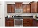 Modern kitchen with stainless steel appliances, dark wood cabinets, and stylish countertops at 2881 Rutherford Way, Charleston, SC 29414