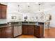Spacious kitchen area with a breakfast bar, sink, and dark brown cabinets at 2881 Rutherford Way, Charleston, SC 29414