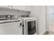 Laundry room features white washer and dryer with white cabinets above them at 2881 Rutherford Way, Charleston, SC 29414