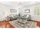 The inviting living room includes neutral paint, hardwood floors, comfortable seating, and a patterned rug at 2881 Rutherford Way, Charleston, SC 29414