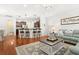Cozy living room with hardwood floors, a neutral rug, comfortable seating, and an open layout to the kitchen at 2881 Rutherford Way, Charleston, SC 29414