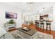 Spacious living area with hardwood floors, a comfortable sofa, decorative elements, and seamless flow to the dining area at 2881 Rutherford Way, Charleston, SC 29414