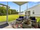 Cozy screened porch with stylish outdoor furniture overlooking a well-maintained lawn and blue skies at 2881 Rutherford Way, Charleston, SC 29414