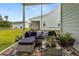 Inviting screened porch boasts comfortable seating and vibrant plants, perfect for relaxing outdoors at 2881 Rutherford Way, Charleston, SC 29414