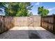 Private backyard with a wooden fence, a small gate and an area covered in rocks at 2947 Sweetleaf Ln, Johns Island, SC 29455