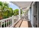 Outdoor balcony with wood flooring and white railings and supports, offering a tranquil view at 2947 Sweetleaf Ln, Johns Island, SC 29455