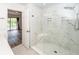 Modern bathroom featuring white marble shower with glass door and hexagon tile floor, with view to main bedroom at 2947 Sweetleaf Ln, Johns Island, SC 29455