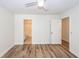 Bedroom with wood-look floors, neutral walls, and two doorways, one to a bathroom with a tub at 2947 Sweetleaf Ln, Johns Island, SC 29455