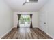 Bright bedroom featuring wood floors, neutral walls, ceiling fan and sliding glass doors to a balcony at 2947 Sweetleaf Ln, Johns Island, SC 29455