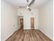 Bright bedroom with modern ceiling fan, hardwood flooring, and multiple doorways at 2947 Sweetleaf Ln, Johns Island, SC 29455