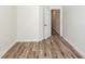 Bedroom with wood-look floors and neutral walls is next to a doorway to another room at 2947 Sweetleaf Ln, Johns Island, SC 29455