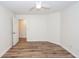 Bright bedroom with a ceiling fan, wood-look floors and a doorway to another room at 2947 Sweetleaf Ln, Johns Island, SC 29455
