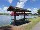 Outdoor canoe storage rack with canoes next to the lake and community in the background at 2947 Sweetleaf Ln, Johns Island, SC 29455