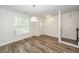 Open dining room with hardwood floors, chair rail, and a window with stylish shutters at 2947 Sweetleaf Ln, Johns Island, SC 29455