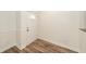 Hallway with wood-look floors, white trim, and white door at 2947 Sweetleaf Ln, Johns Island, SC 29455