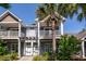Two-story townhome featuring double balconies, wood accents and inviting entrance at 2947 Sweetleaf Ln, Johns Island, SC 29455