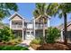 Charming two-story townhome with double balconies, a pergola, and lush landscaping at 2947 Sweetleaf Ln, Johns Island, SC 29455