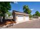 Two-car detached garage with white doors and tan siding at 2947 Sweetleaf Ln, Johns Island, SC 29455