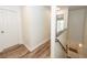 Bright hallway featuring wood-look floors and a staircase leading to an upper floor at 2947 Sweetleaf Ln, Johns Island, SC 29455