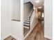 Inviting hallway showcasing hardwood floors and stairs with white trim, complemented by neutral walls at 2947 Sweetleaf Ln, Johns Island, SC 29455