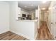 Modern kitchen with white cabinets, stainless steel appliances, breakfast bar, and hardwood flooring throughout at 2947 Sweetleaf Ln, Johns Island, SC 29455