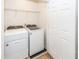 Laundry room with front-loading white washer and dryer, wire shelving, and a white door at 2947 Sweetleaf Ln, Johns Island, SC 29455