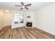 Cozy living room features hardwood floors, fireplace, large window, and a ceiling fan to provide year-round comfort at 2947 Sweetleaf Ln, Johns Island, SC 29455