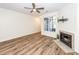 Bright living room featuring hardwood floors, fireplace, ceiling fan, and a large window for natural light at 2947 Sweetleaf Ln, Johns Island, SC 29455